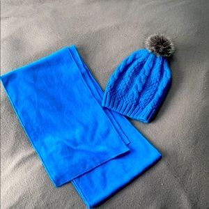 Bundle of blue knit beanie and scarf.